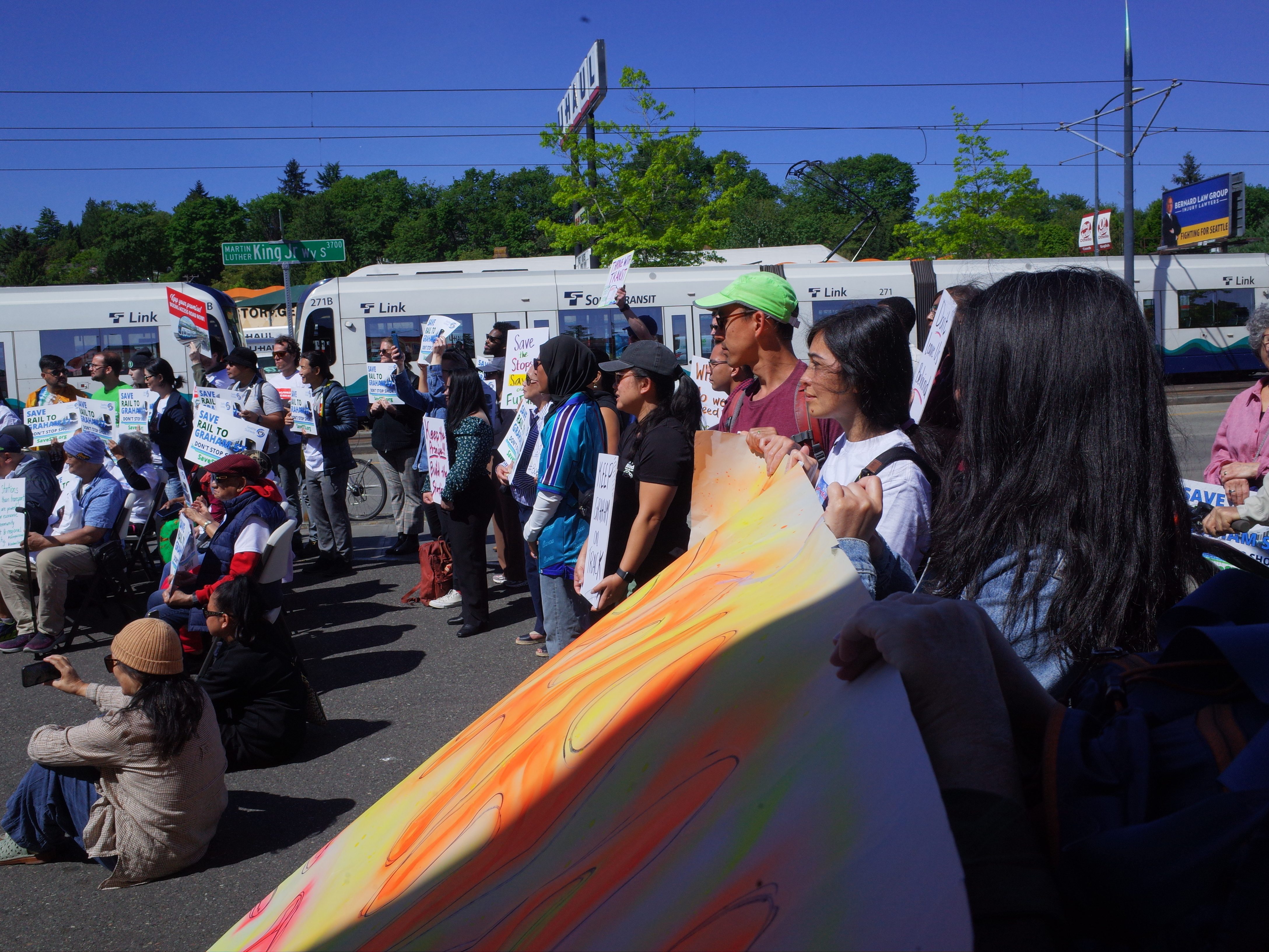 A group of activists near a light rail station